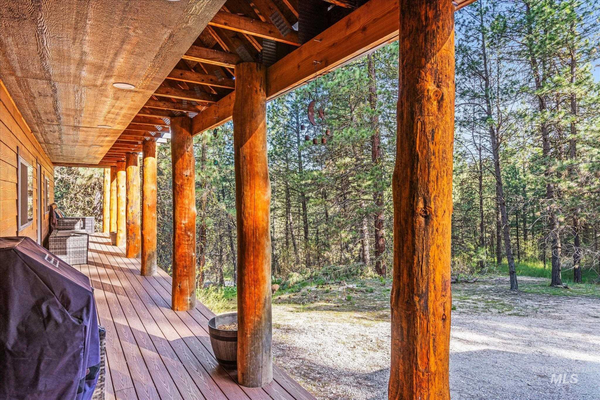 1 Sunset Trail Banks, ID 83602 - Photo 5 of 42 Expansive outdoor deck featuring wood-finish flooring, natural wood columns, recessed lighting, and a wood-paneled ceiling