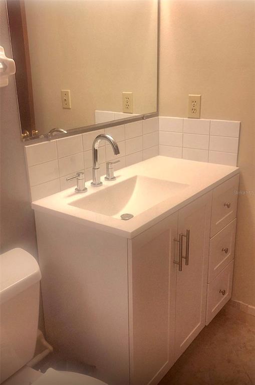 8417 Southwest 106th Street Ocala, FL 34481 - Photo 20 of 49 a bathroom with a sink and a mirror