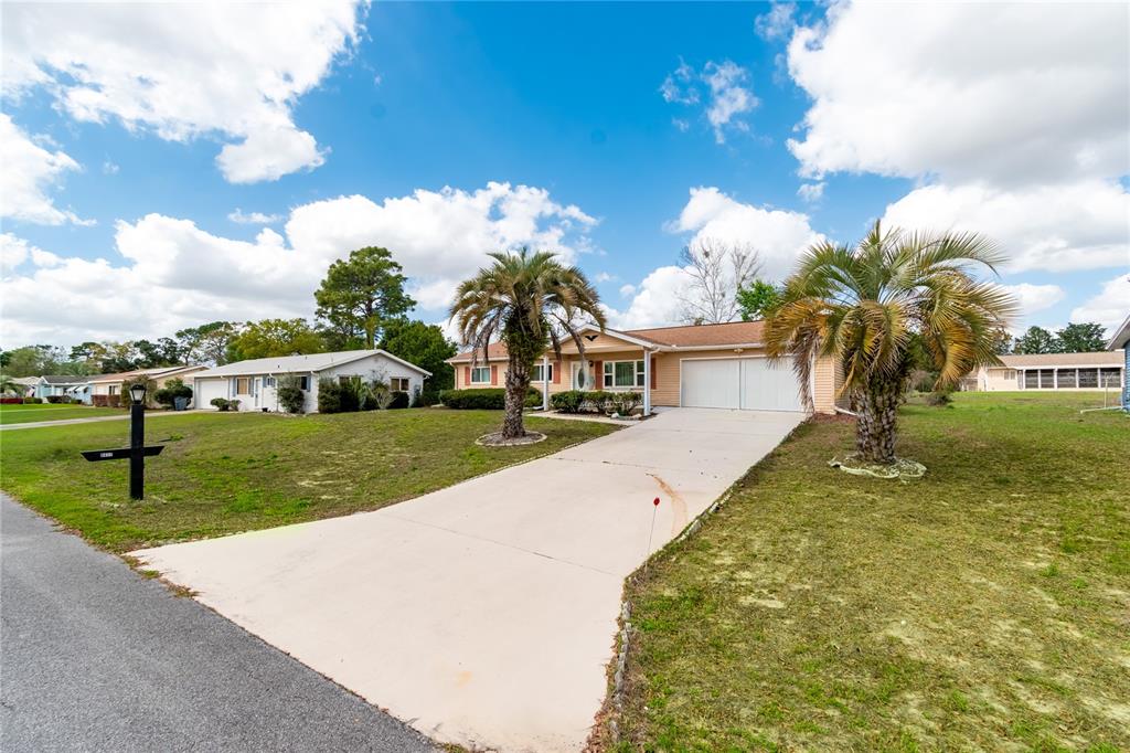 8417 Southwest 106th Street Ocala, FL 34481 - Photo 28 of 49 a front view of a house with garden