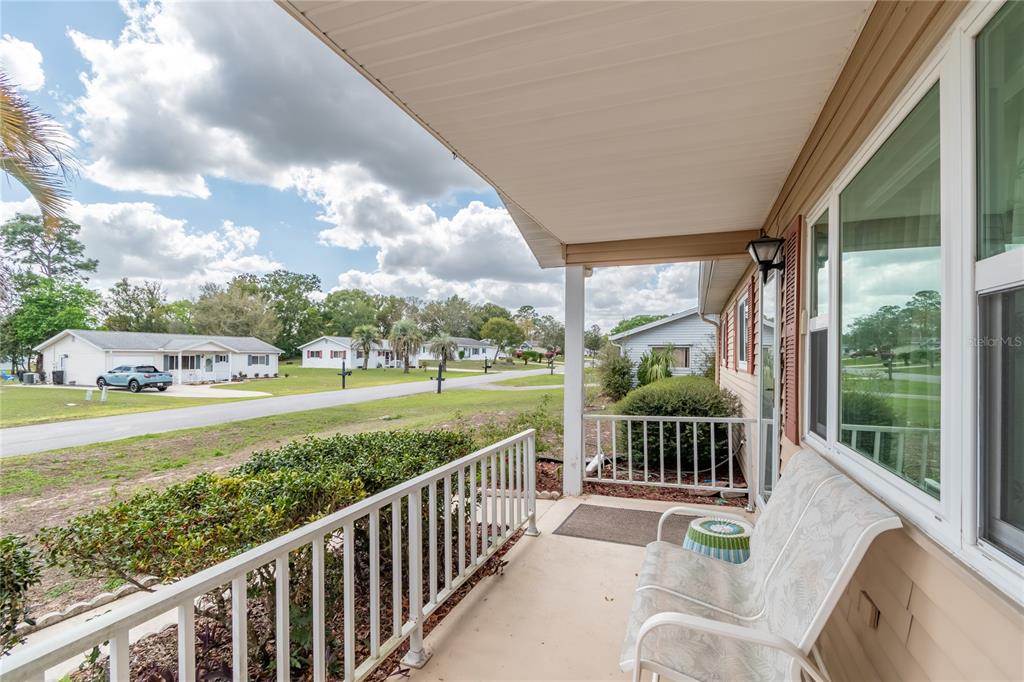 8417 Southwest 106th Street Ocala, FL 34481 - Photo 3 of 49 a view of a balcony with floor to ceiling windows with wooden floor