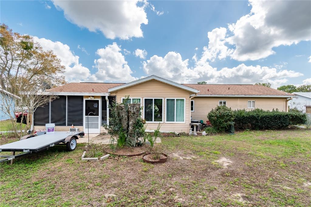 8417 Southwest 106th Street Ocala, FL 34481 - Photo 31 of 49 a front view of a house with garden