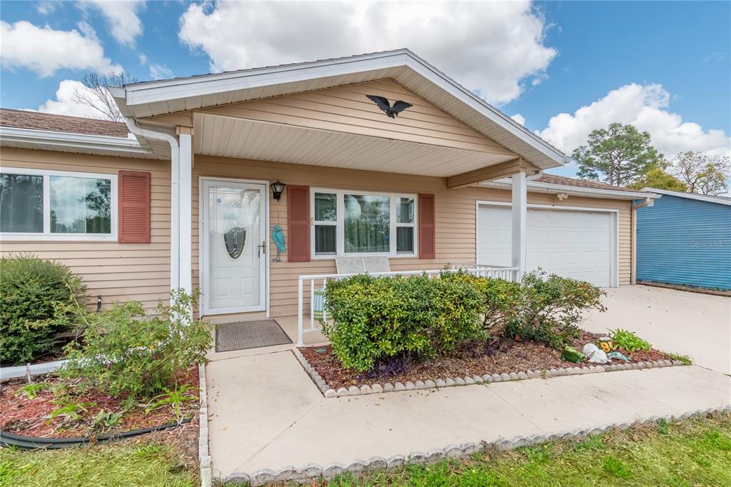 8417 Southwest 106th Street Ocala, FL 34481 - Photo 34 of 49 front view of the house with potted plants