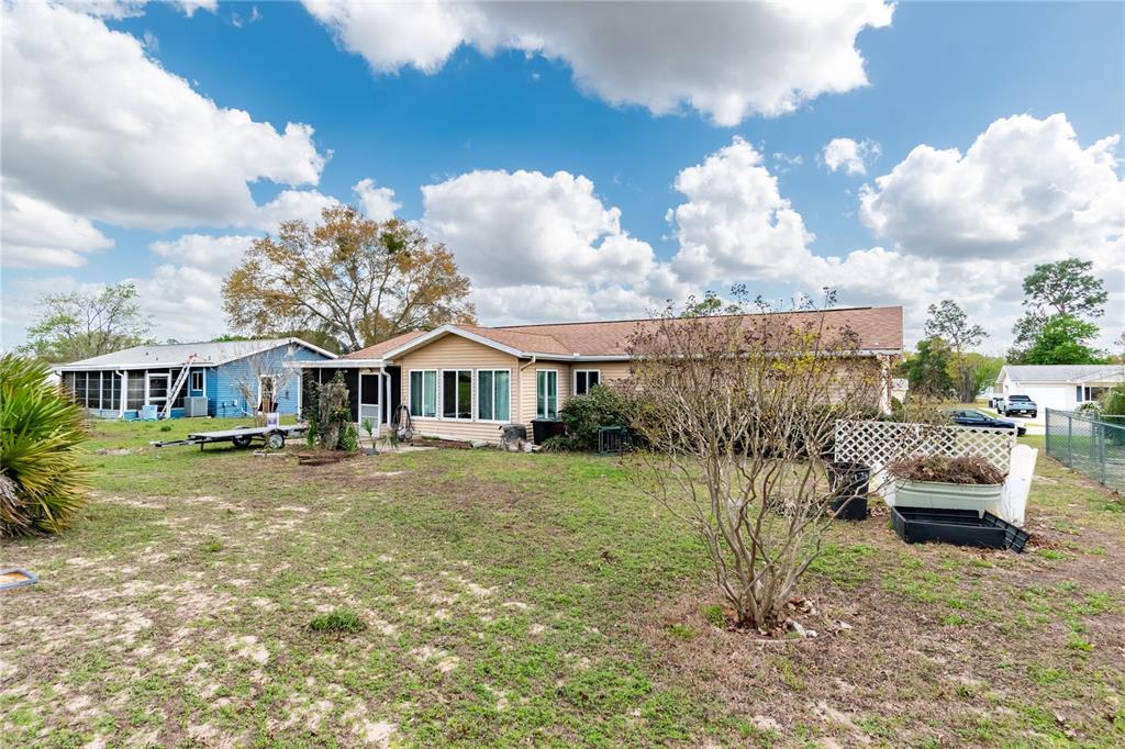 8417 Southwest 106th Street Ocala, FL 34481 - Photo 36 of 49 a view of a house with a yard