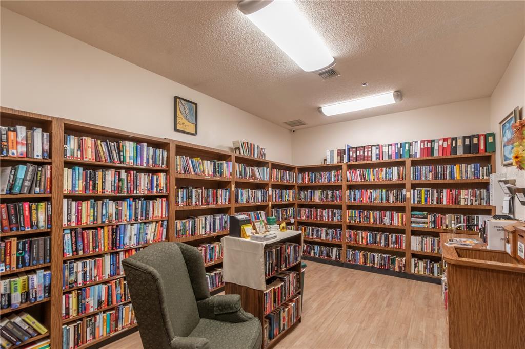 8417 Southwest 106th Street Ocala, FL 34481 - Photo 43 of 49 a view of a workspace with furniture and a bookshelf