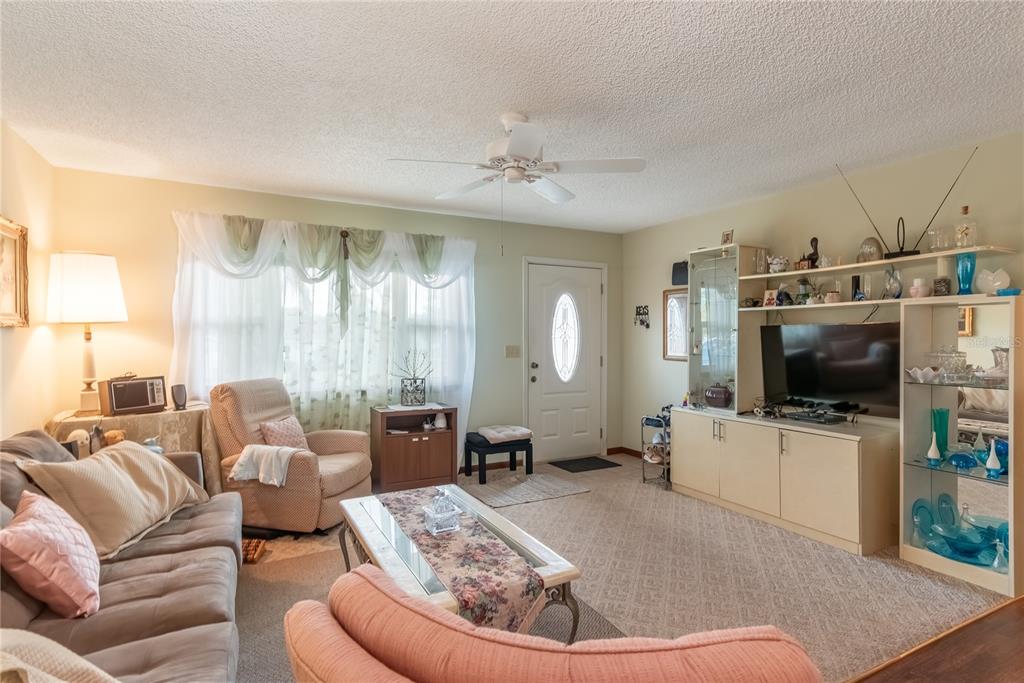 8417 Southwest 106th Street Ocala, FL 34481 - Photo 5 of 49 a living room with furniture and a flat screen tv