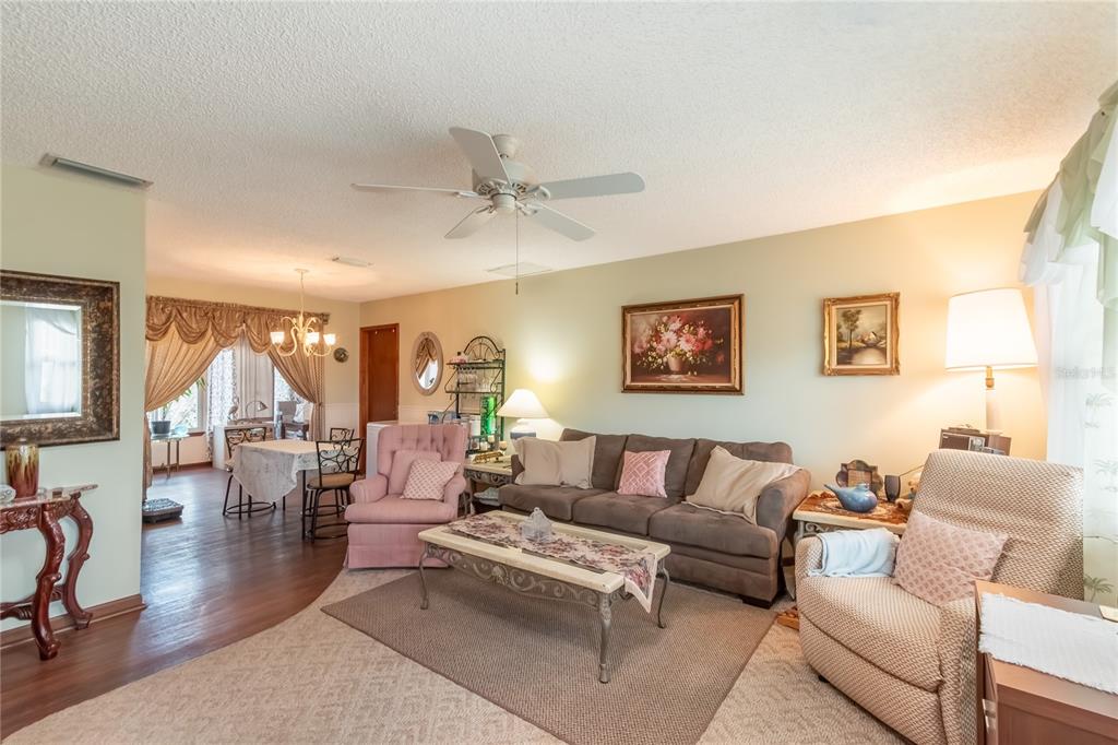 8417 Southwest 106th Street Ocala, FL 34481 - Photo 6 of 49 a living room with furniture and wooden floor