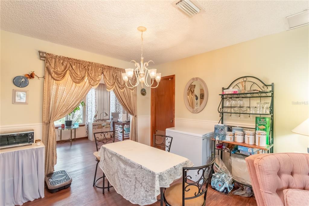 8417 Southwest 106th Street Ocala, FL 34481 - Photo 7 of 49 a living room with furniture a rug and a chandelier