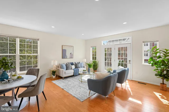 a living room with furniture and potted plants