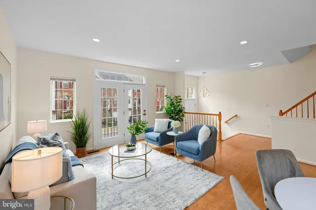 a living room with furniture and wooden floor