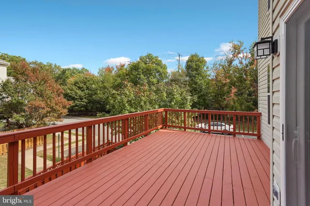 a view of balcony with wooden floor and fence