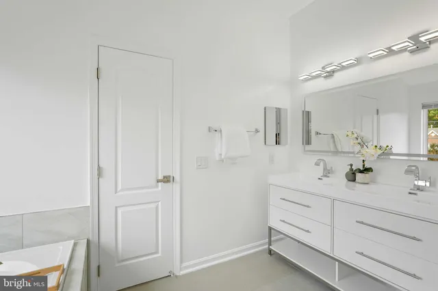 a bathroom with a double vanity sink a mirror and shower