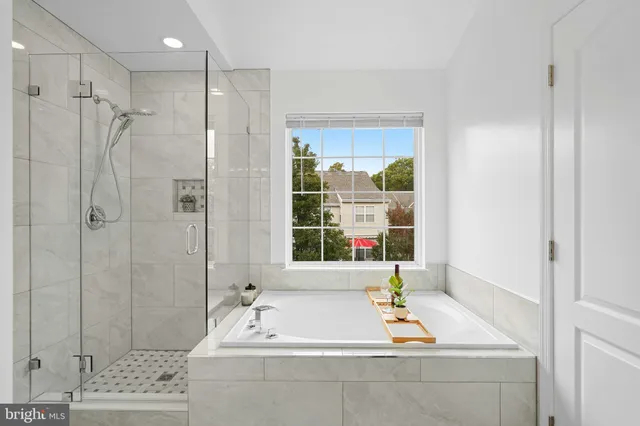 a bathroom with a tub a sink and a window