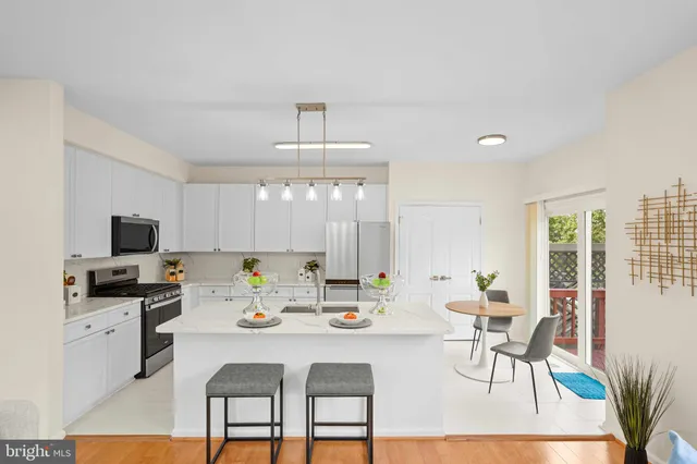 a kitchen with a dining table and chairs