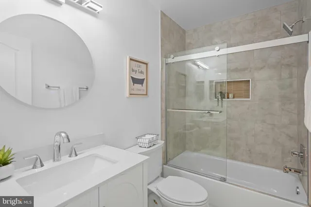 a bathroom with a sink mirror bathtub and toilet
