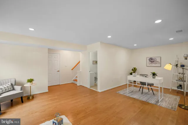 a living room with furniture and stairs