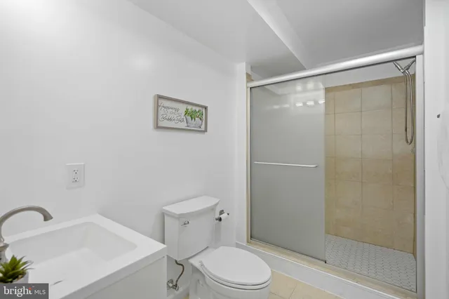 a white toilet sitting next to a bath tub