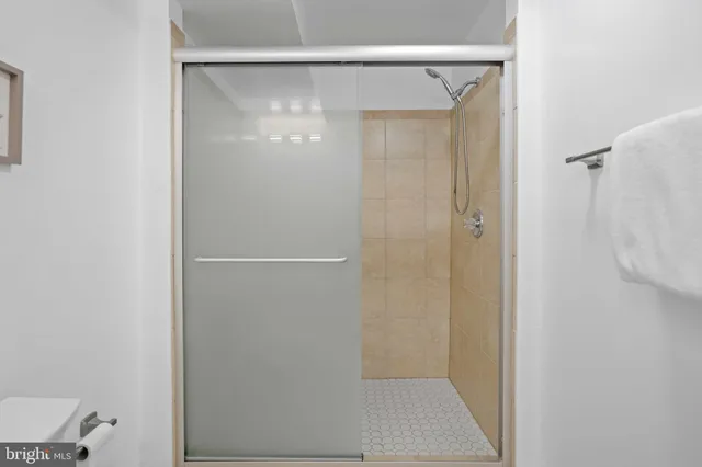 a bathroom with a glass shower door