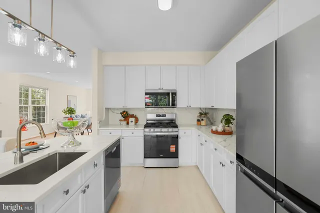 a kitchen with a sink cabinets and stainless steel appliances