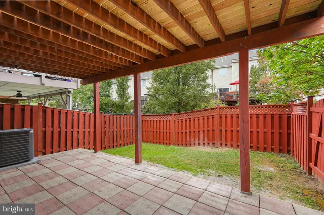 a view of a backyard with wooden fence