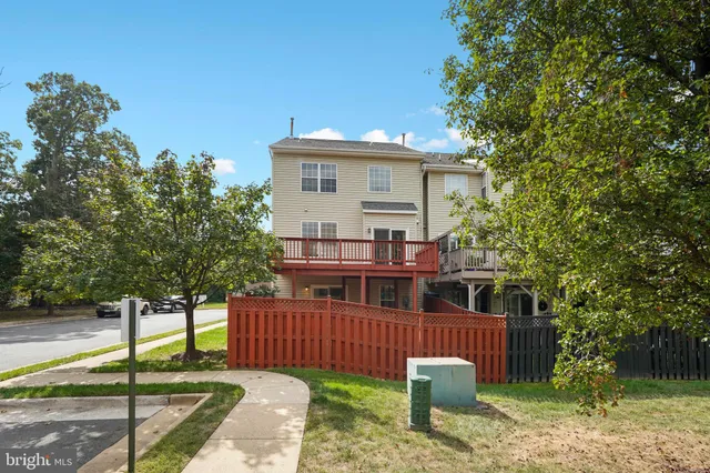 a view of a house with a small yard plants and large tree