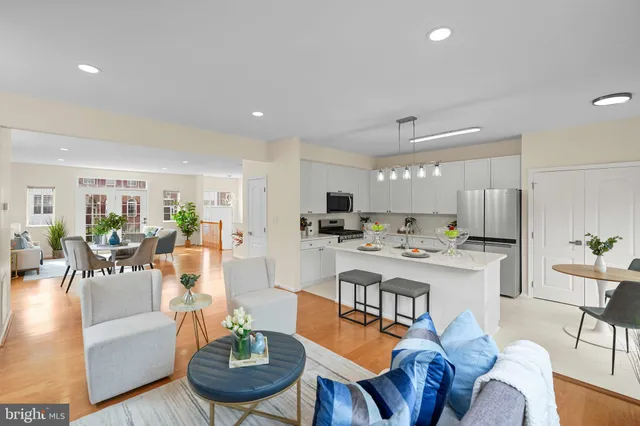 a living room with furniture kitchen and a table