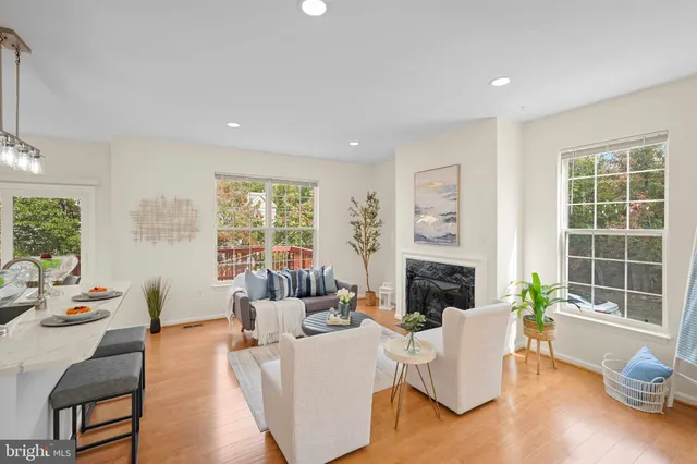 a living room with fireplace furniture and a large window