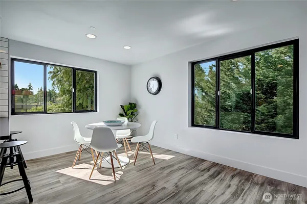 a view of a dining room with furniture window and wooden floor