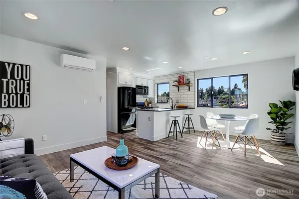 a living room with kitchen view and kitchen view with wooden floor