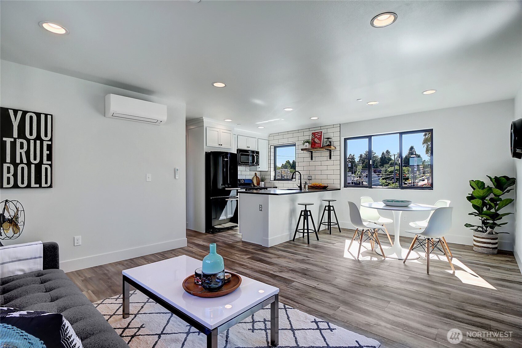 1126 North 90th Street Seattle, WA 98103 - Photo 2 of 15 a living room with kitchen view and kitchen view with wooden floor