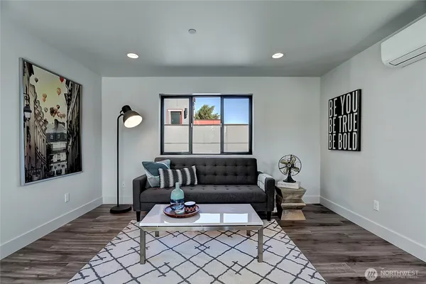 a living room with furniture and wooden floor