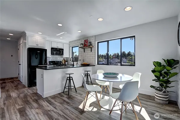 a dining room with furniture and window