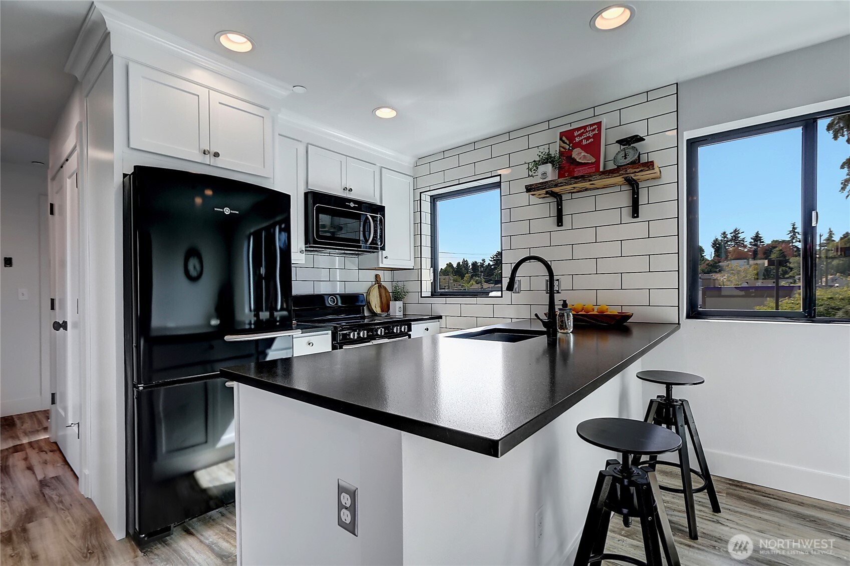 1126 North 90th Street Seattle, WA 98103 - Photo 8 of 15 a kitchen with kitchen island a sink appliances and cabinets