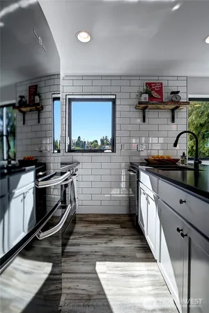 a kitchen with stainless steel appliances a stove and cabinets