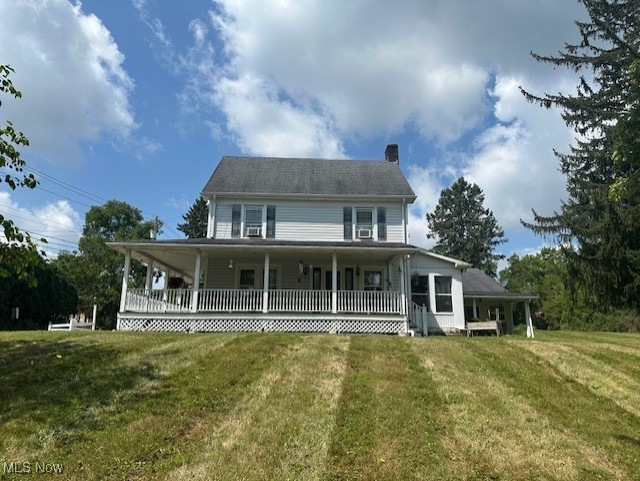 976 East Calla Road Youngstown, OH 44514 - Photo 2 of 10 Farmhouse-style home featuring covered porch, a chimney, and a front yard