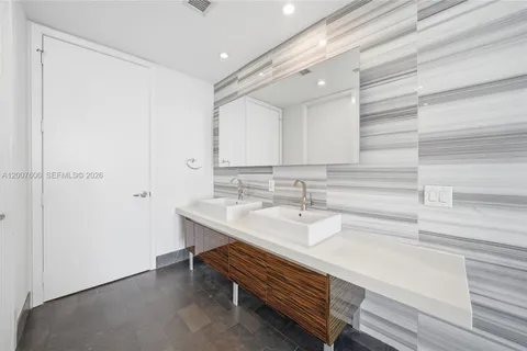 a bathroom with a sink a mirror and a shower