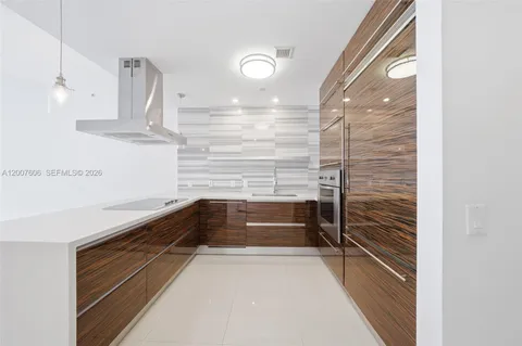 a large kitchen with kitchen island a sink stainless steel appliances and cabinets