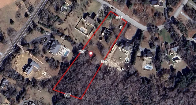 a view of a yard with large trees