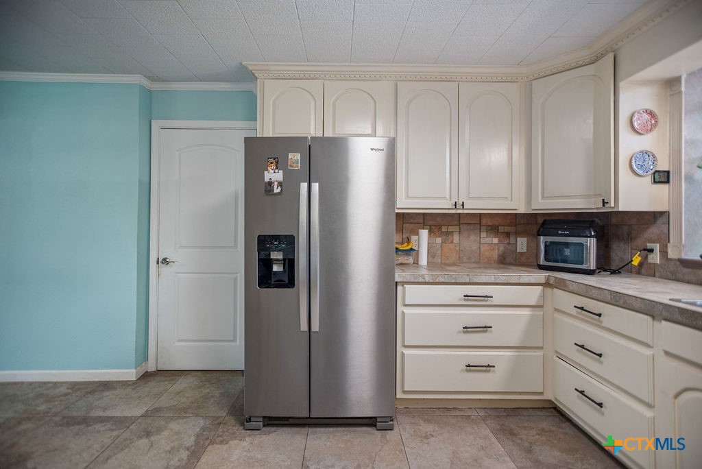 1315 Jackson Street Port Lavaca, TX 77979 - Photo 17 of 32 a kitchen with white cabinets and stainless steel appliances