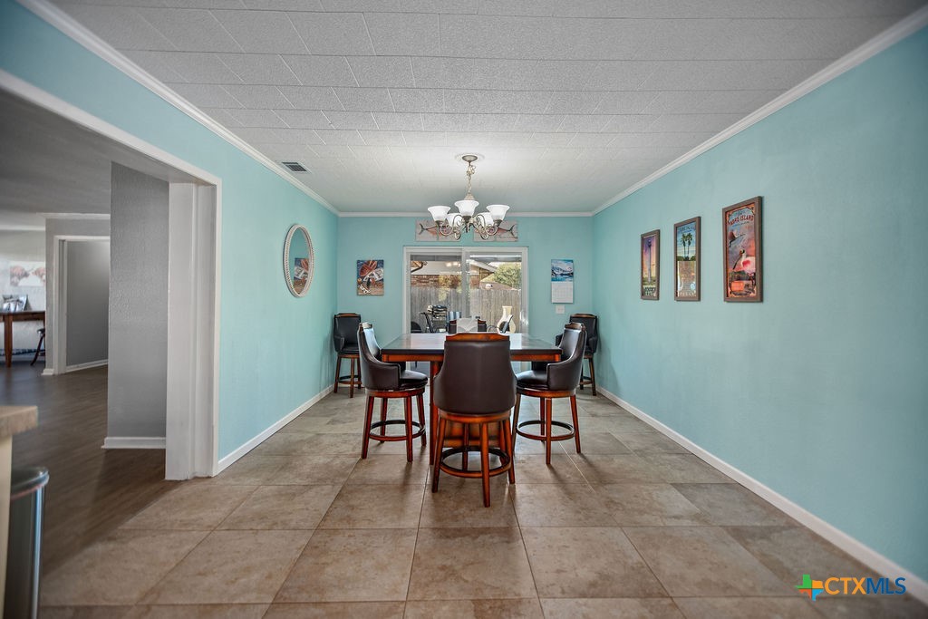 1315 Jackson Street Port Lavaca, TX 77979 - Photo 18 of 32 a view of a dining room with furniture and chandelier