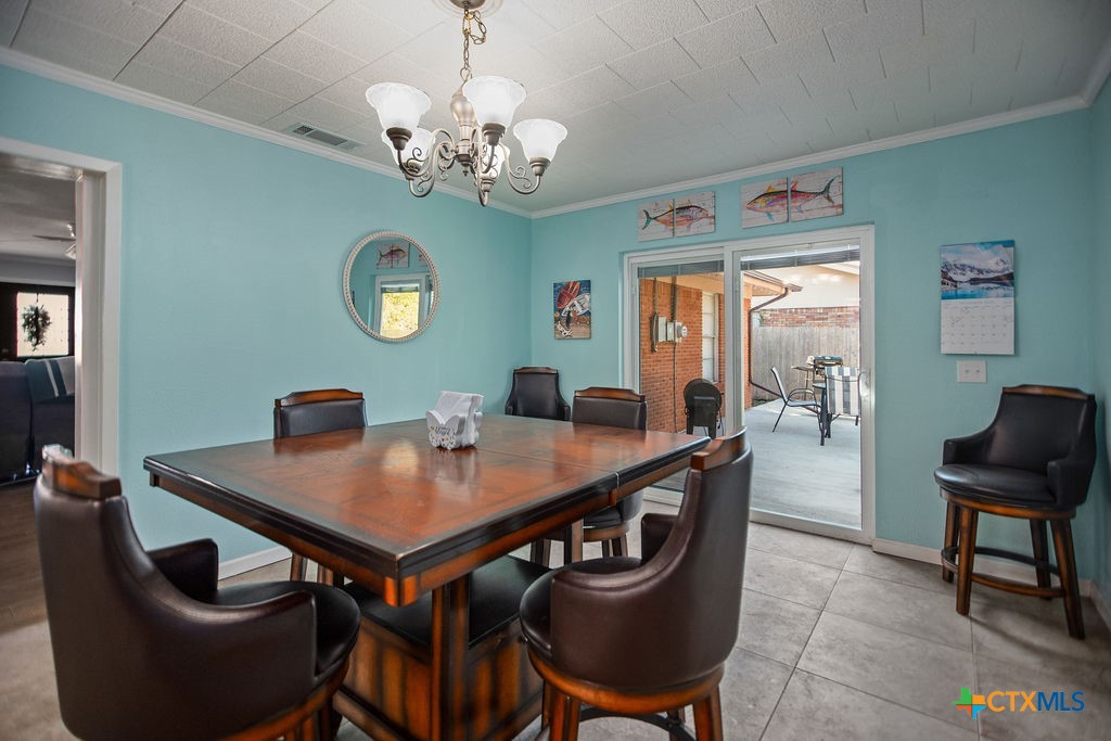 1315 Jackson Street Port Lavaca, TX 77979 - Photo 19 of 32 a view of a dining room with furniture and a chandelier