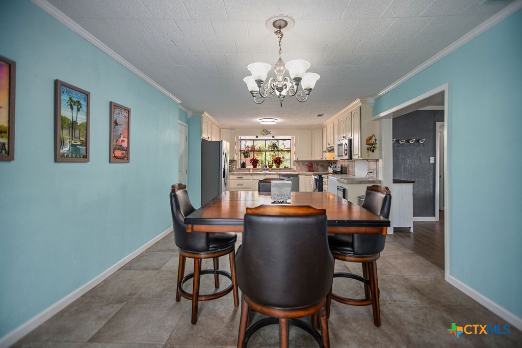 1315 Jackson Street Port Lavaca, TX 77979 - Photo 20 of 32 a dining room with furniture a chandelier and wooden floor