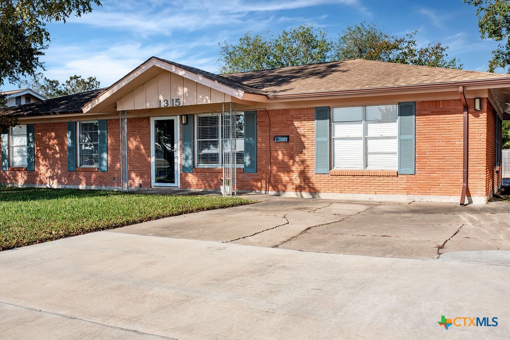 1315 Jackson Street Port Lavaca, TX 77979 - Photo 2 of 32 a front view of a house with a yard and potted plants