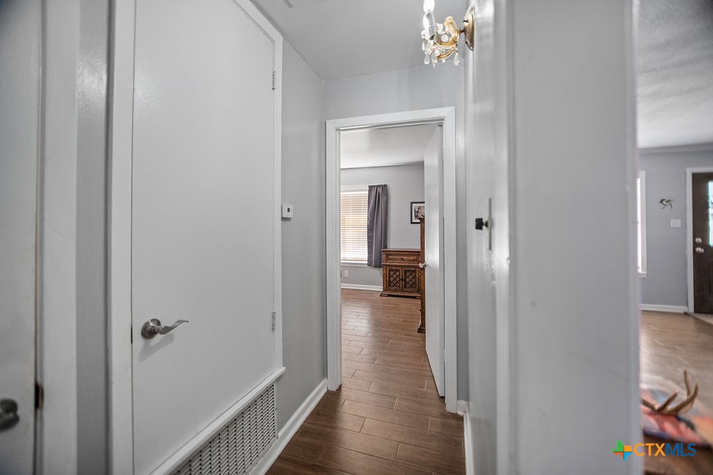 1315 Jackson Street Port Lavaca, TX 77979 - Photo 21 of 32 a view of a hallway with wooden floor and a bathroom
