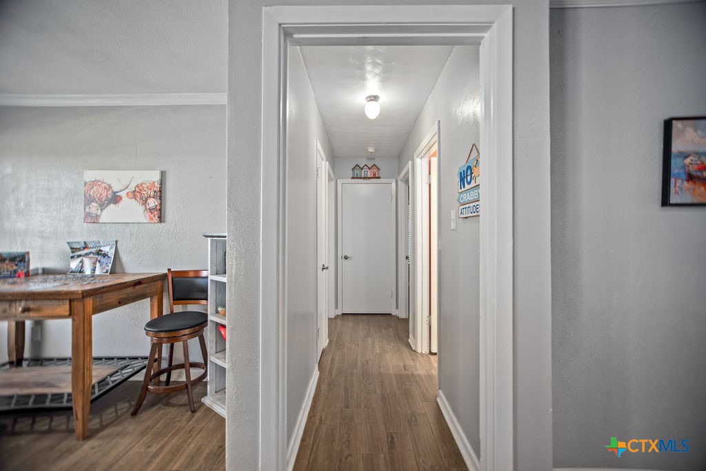1315 Jackson Street Port Lavaca, TX 77979 - Photo 30 of 32 a view of a hallway to a livingroom with furniture and wooden floor