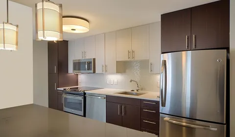 a kitchen with stainless steel appliances a refrigerator and a stove