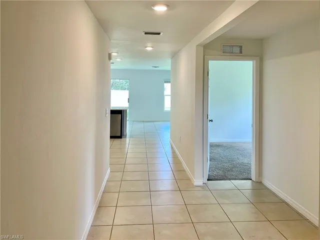 a view of a hallway with closet and door
