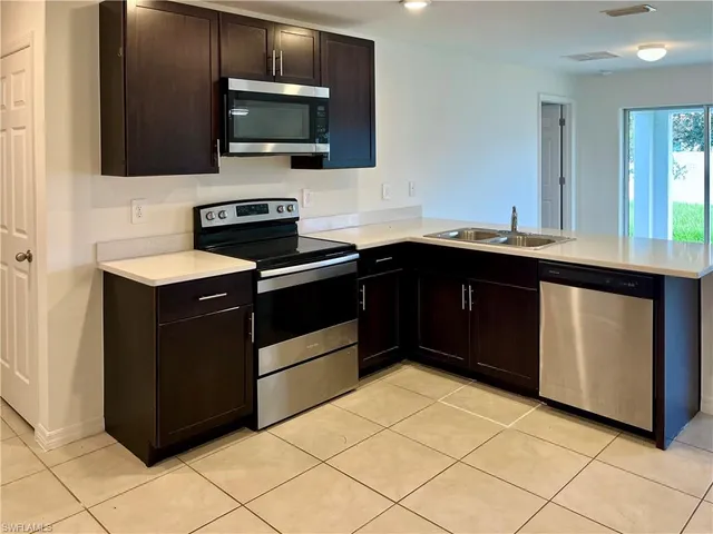 a kitchen with a sink and a stove top oven