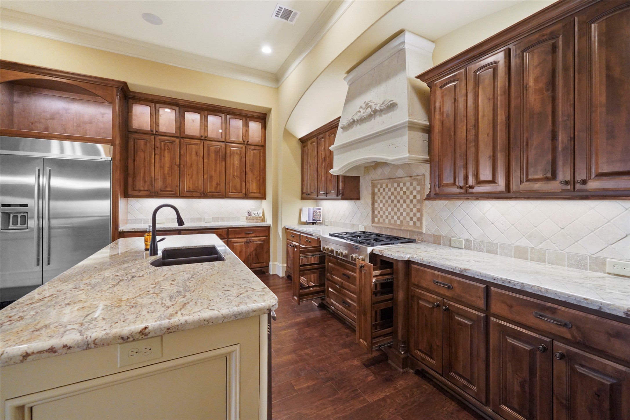 18 Rugged Lark Circle Tomball, TX 77377 - Photo 14 of 50 Show stopper Cooktop area - 6 burner cook top - Hidden Spice/Storage racks - Custom backsplash - Decorative Hood Vent highlights this dream Kitchen!