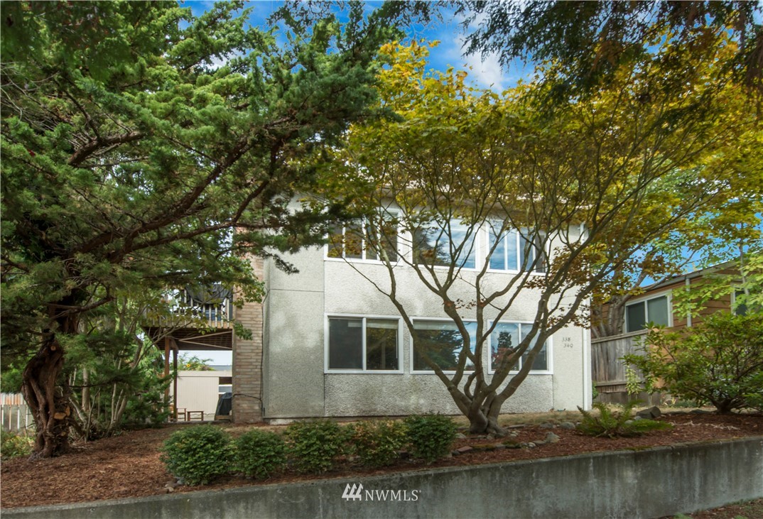 338 Northwest 46th Street Seattle, WA 98107 - Photo 2 of 25 a front view of a house with a yard and garage