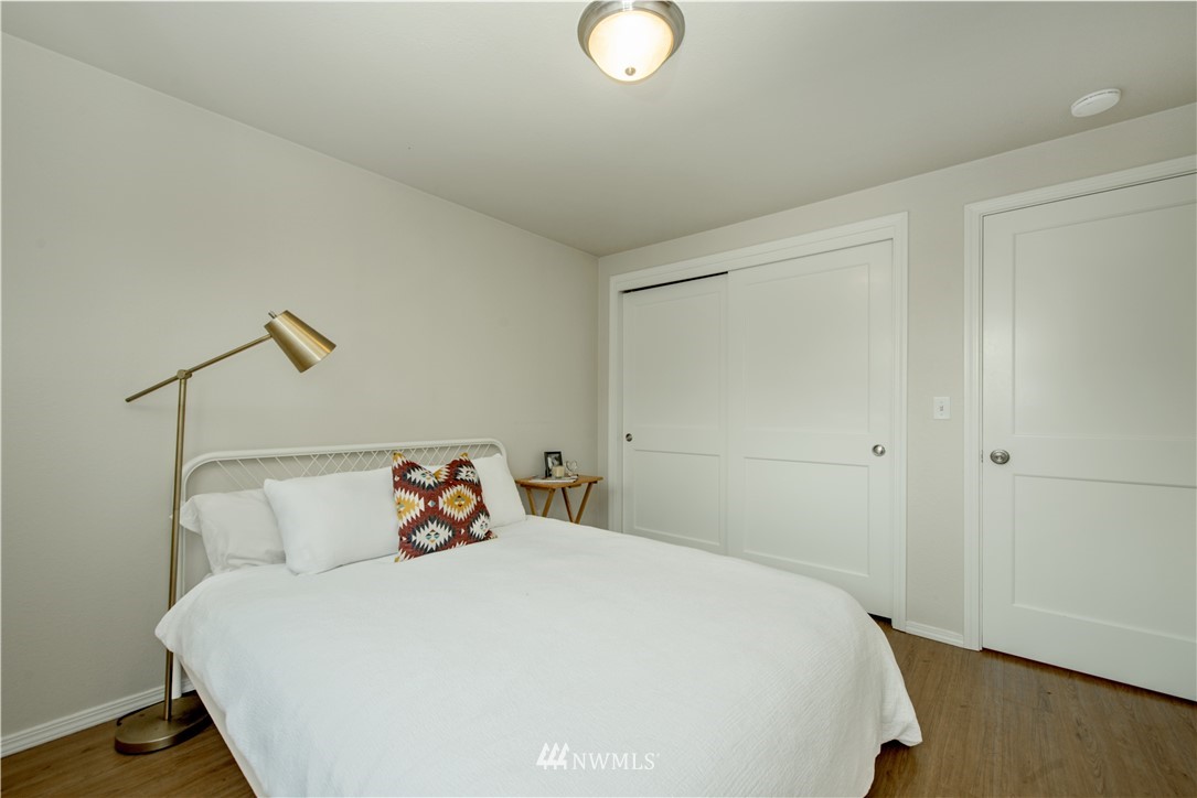 338 Northwest 46th Street Seattle, WA 98107 - Photo 13 of 25 a bedroom with a bed and wooden floor